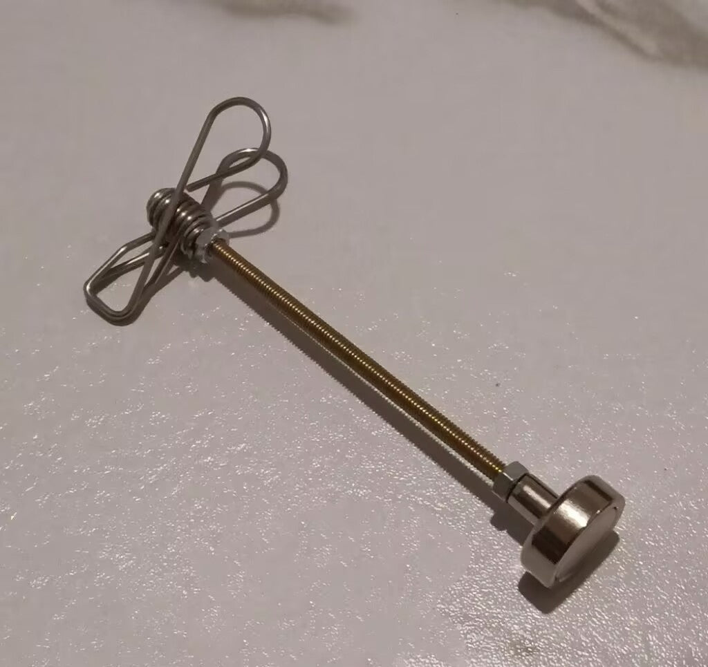 Metal rod with a spring and clip on a light gray background