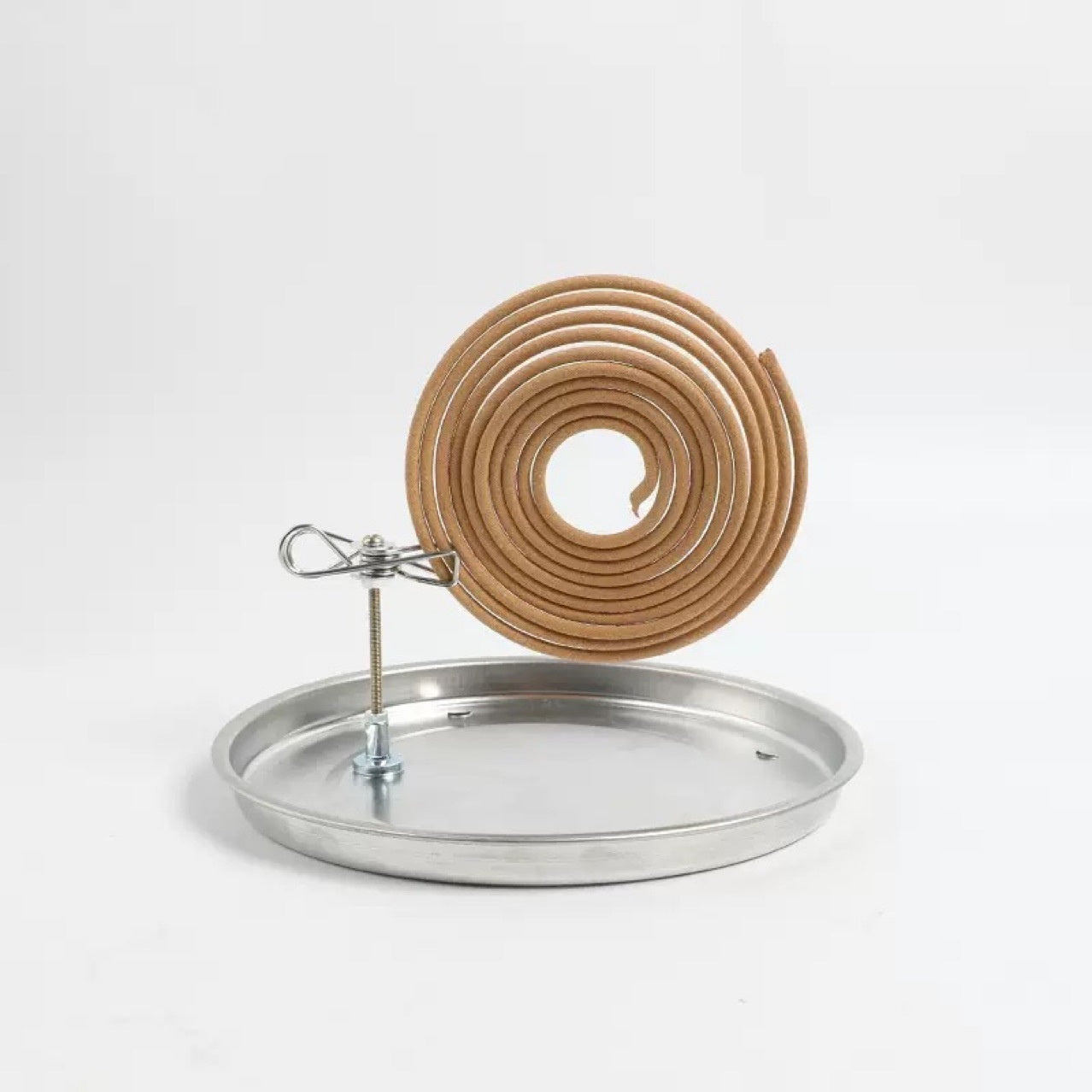 Coil of brown material on a metal stand with a white background