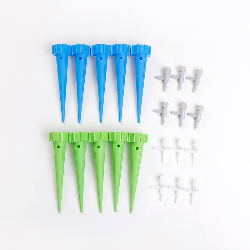 Set of blue and green plastic tent stakes on a white background