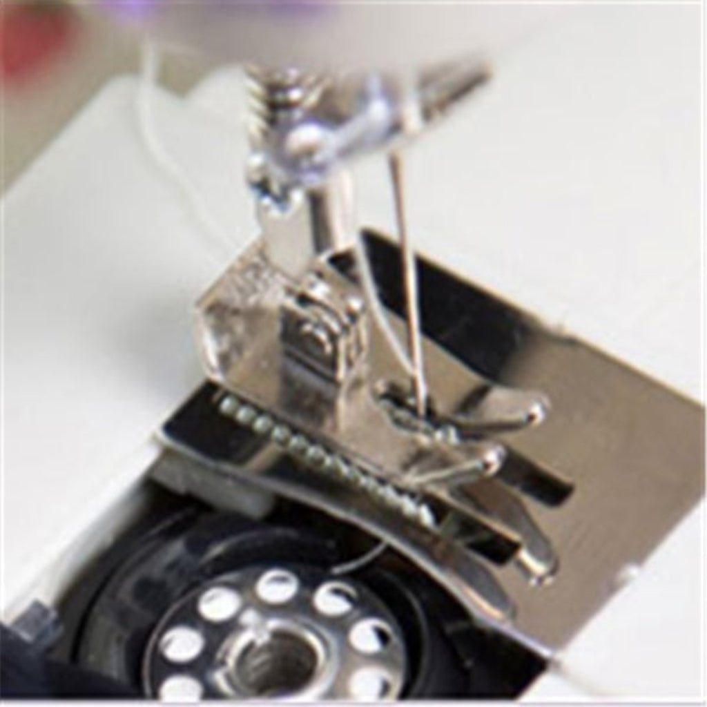 Close-up of a sewing machine needle and presser foot on a white background