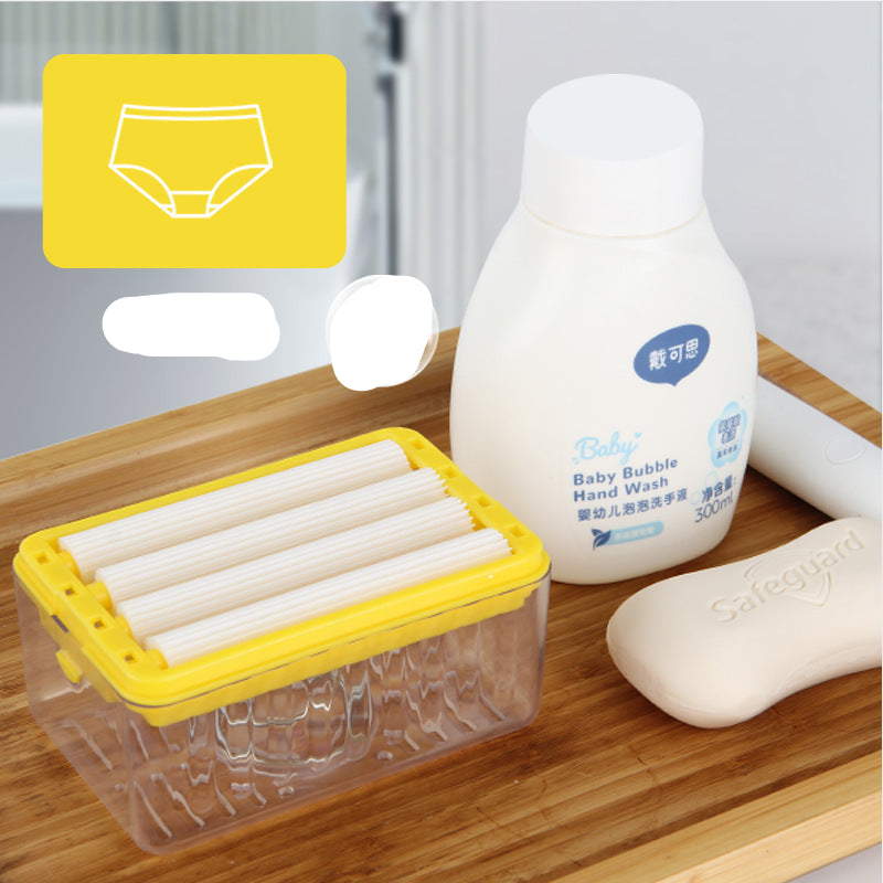 Baby care products including a bottle of baby bubble hand wash, a container of baby wipes, and a soap bar on a wooden surface.
