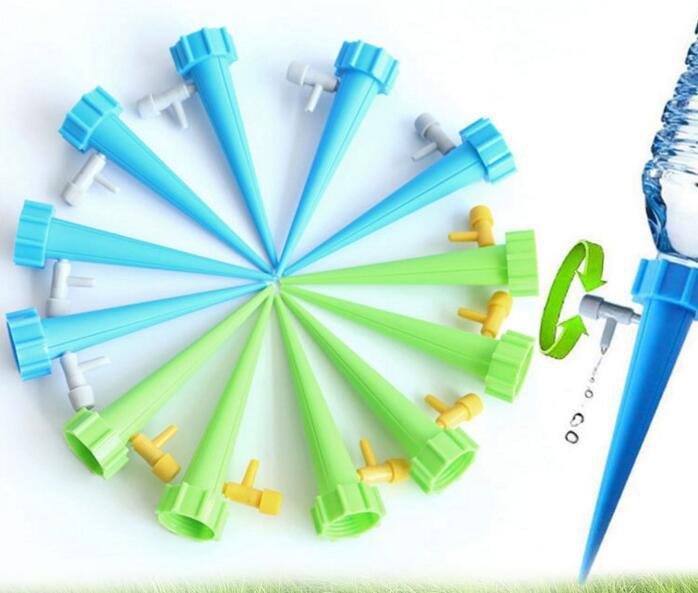 Set of green and blue garden nozzles with a water bottle on a white background