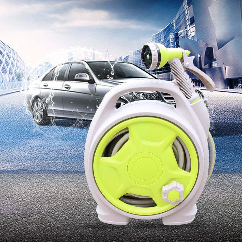 Green and white hose reel with car washing in the background