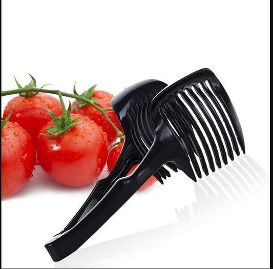 Black kitchen tool with a comb-like design on a white background with tomatoes.