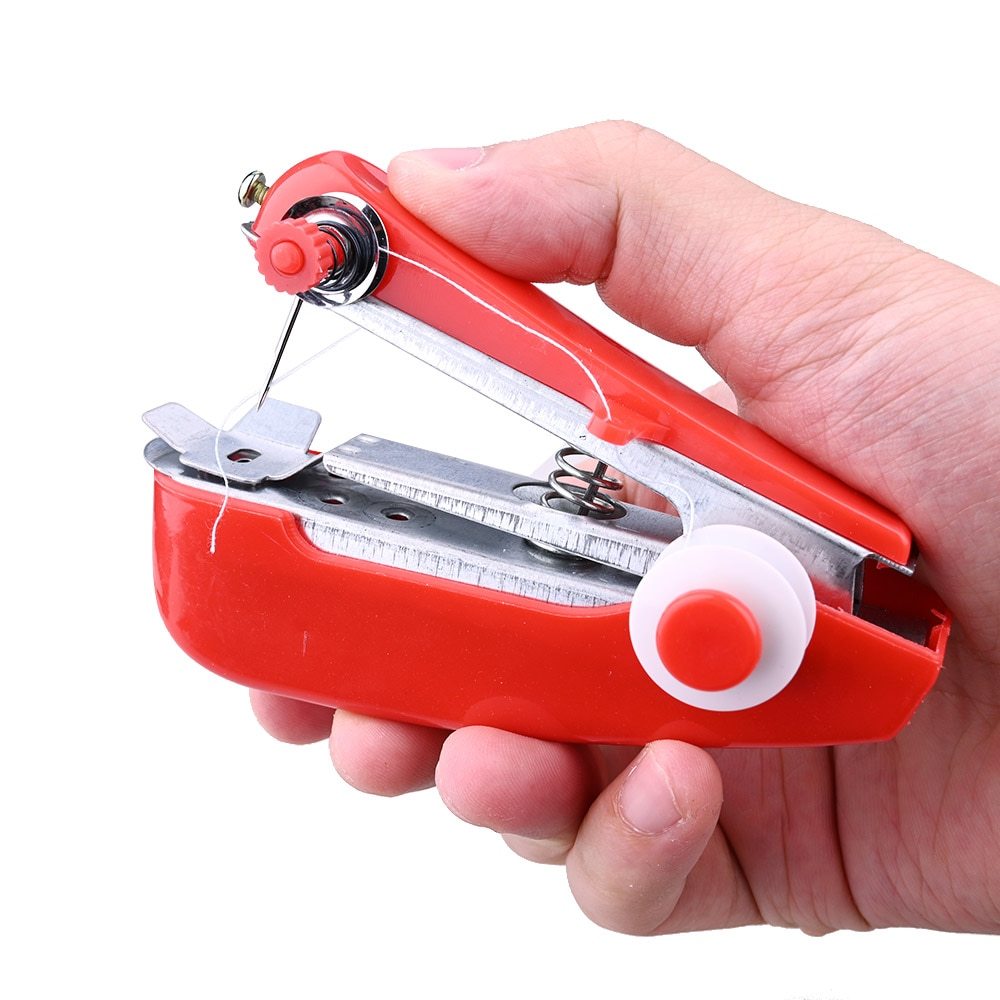Hand holding a red sewing machine needle threader against a white background