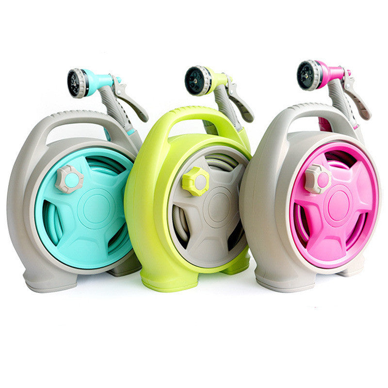 Three colorful garden hoses with nozzles on a white background