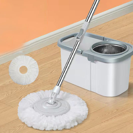 Mop with white cleaning head and gray handle on a wooden floor.