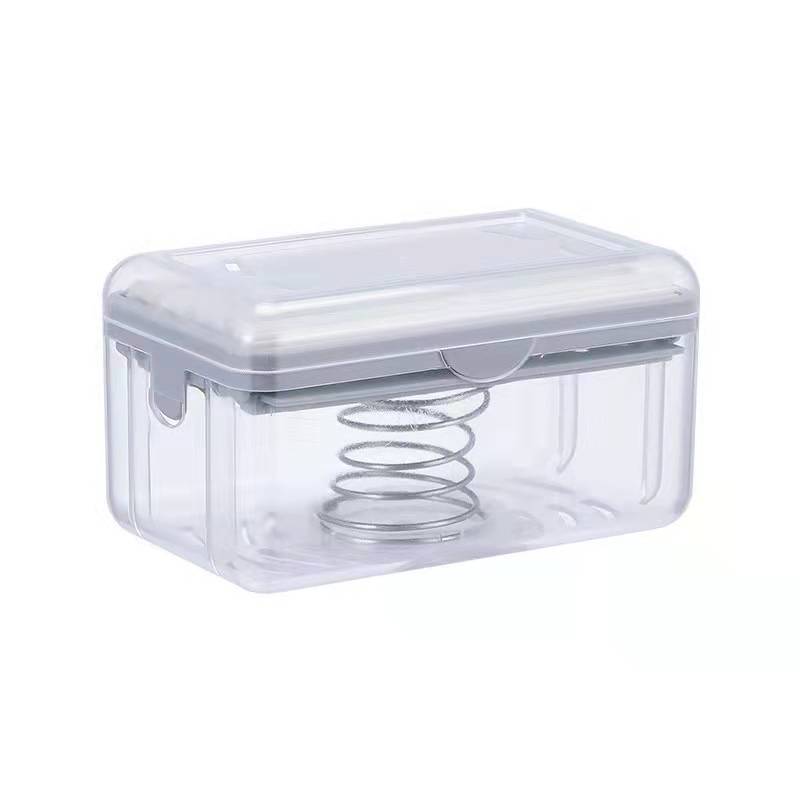 Clear plastic container with a spring inside on a white background