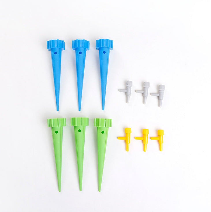 Set of blue and green plastic tent stakes with additional components on a white background