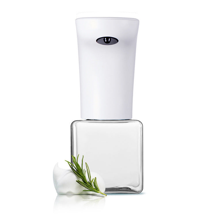 Clear nail polish bottle with white cap and a sprig of rosemary on a white background