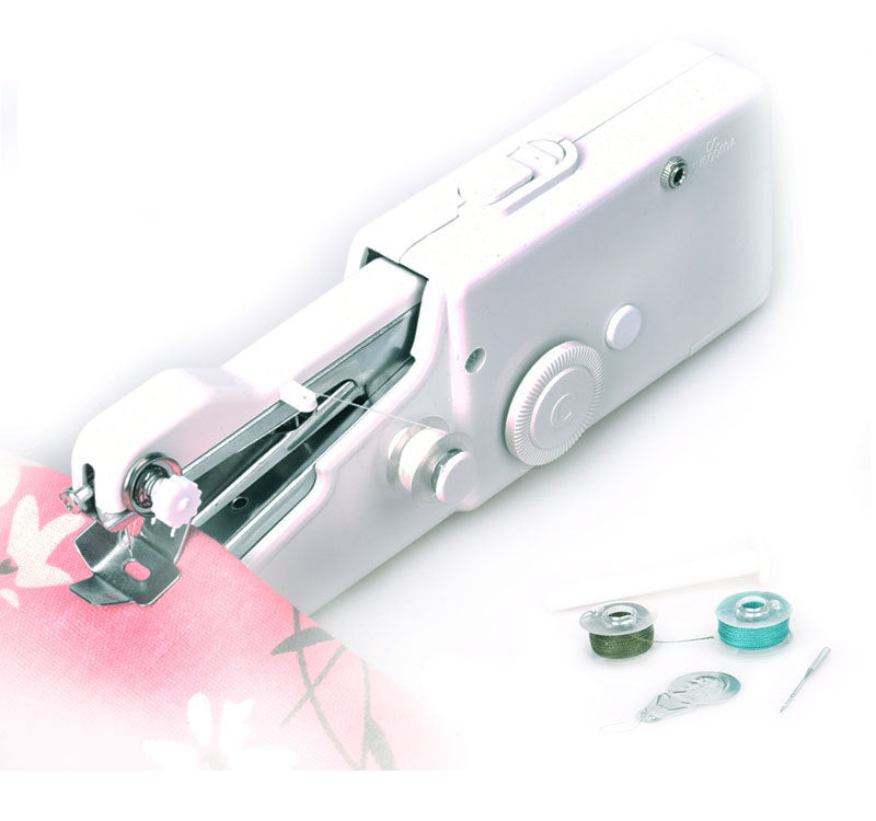 White handheld sewing machine with spools of thread on a light background
