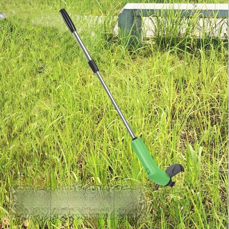 Gardening tool with a green handle and black accents on grass