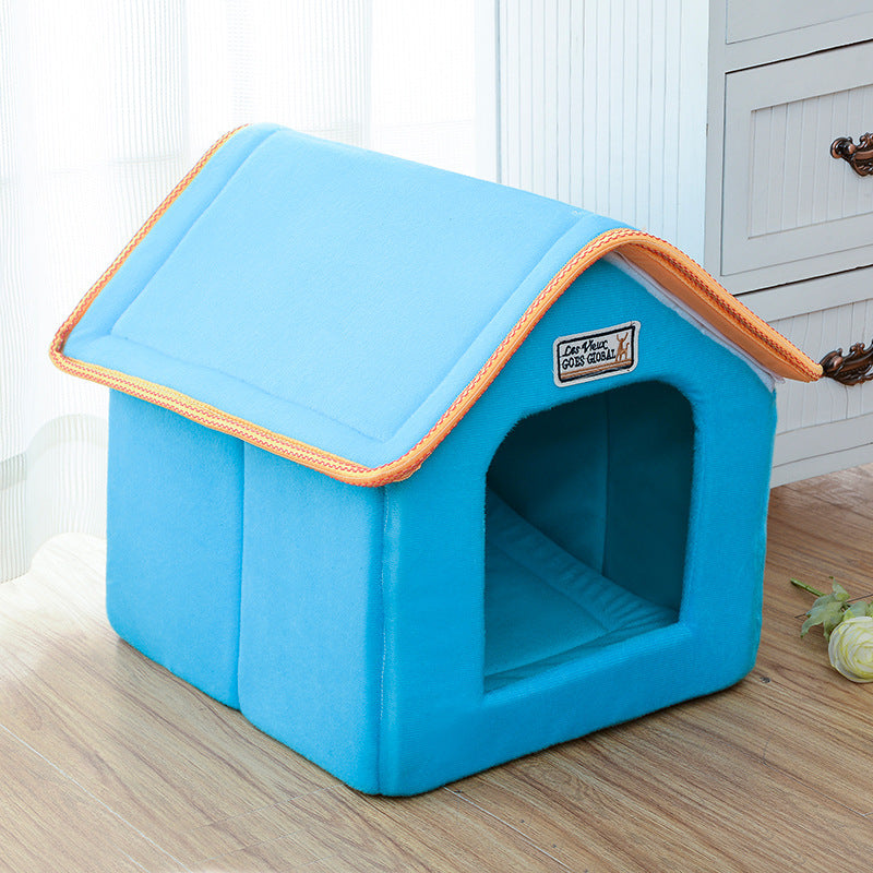 Blue pet house with orange trim on a wooden floor