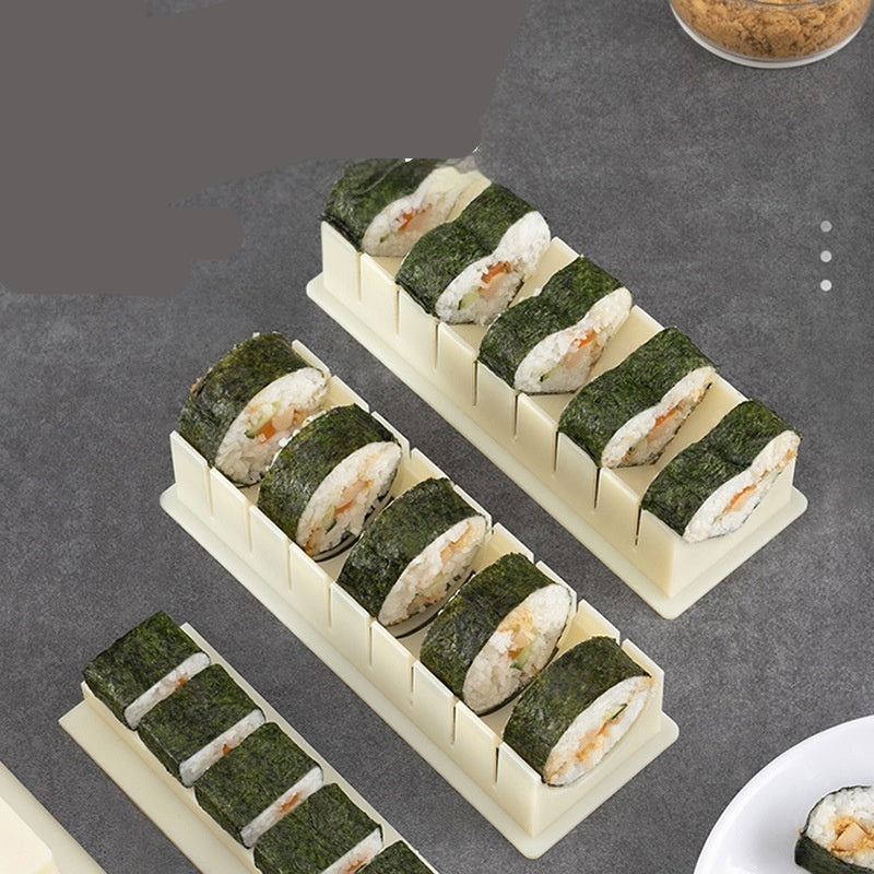 Sushi mold box with pre-formed sushi rolls on a gray background