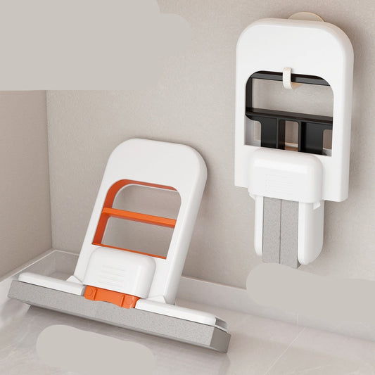 White and orange kitchen tool with stand and wall hanging feature on a neutral background