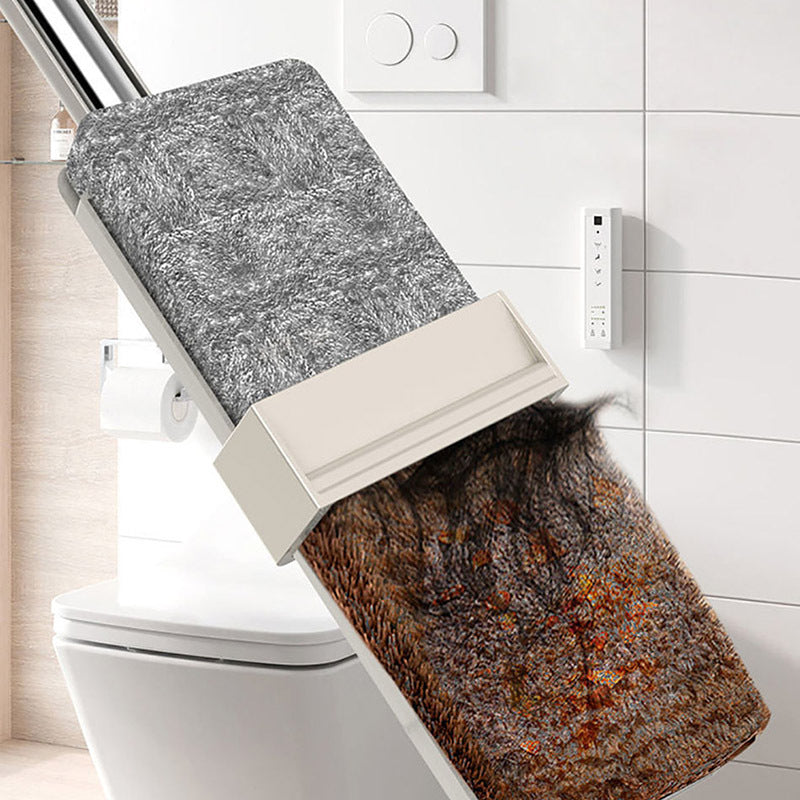 Cleaning tool with a gray scrubber and brown brush head against a bathroom background
