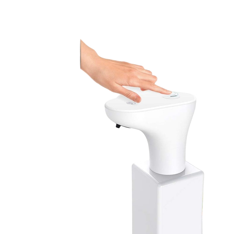 Hand pressing a button on a white toilet with a black sidebar.