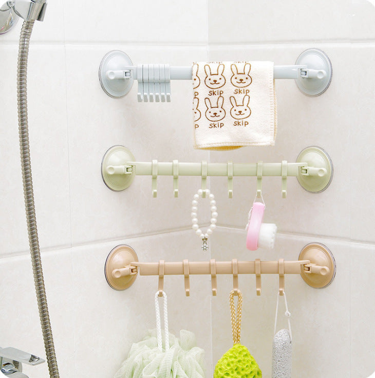 Wall-mounted shower caddy with multiple hooks holding various items on a white tiled wall.