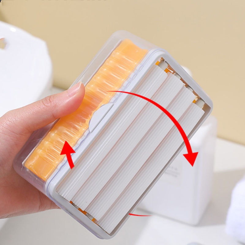 Hand holding a plastic container with orange and white cleaning brush heads, with red arrows indicating direction.