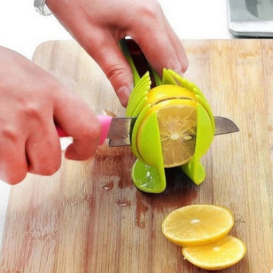 Person using a lemon squeezer on a wooden cutting board with sliced lemons.