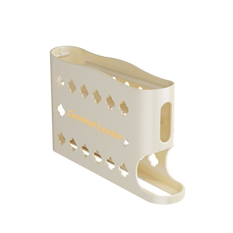 Beige magazine holder with cut-out design on a white background