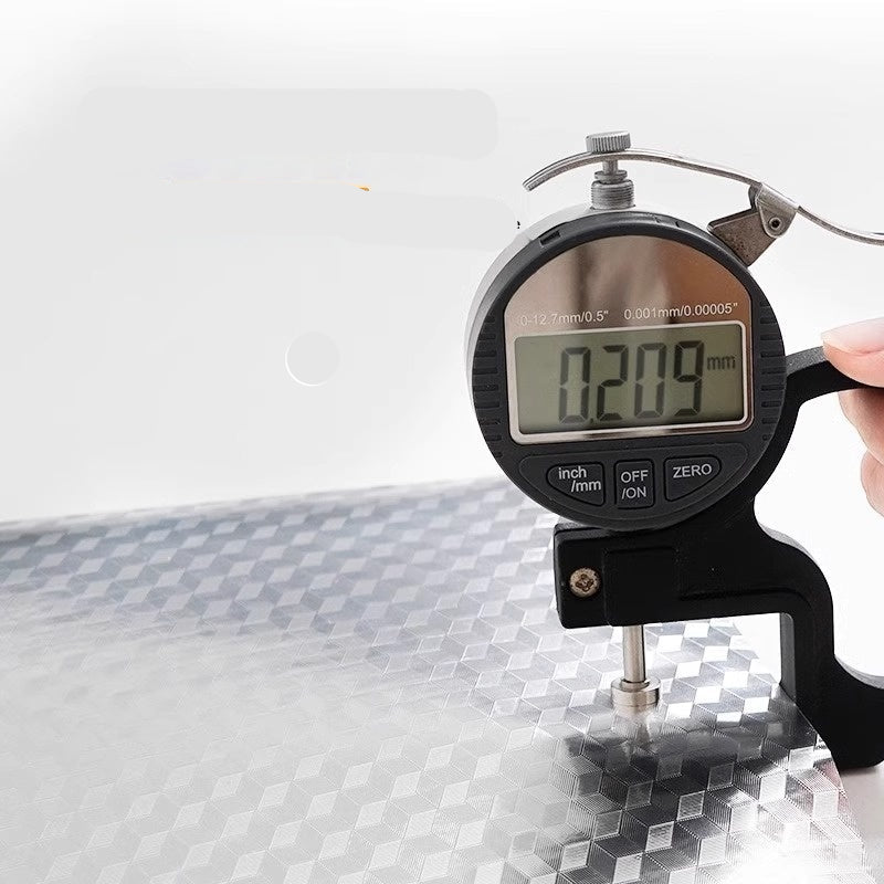 Digital dial indicator measuring thickness with a white background