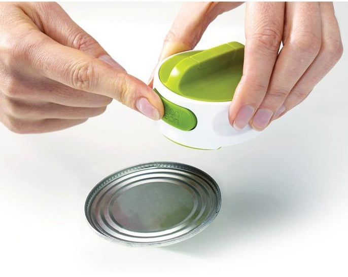 Person using a can opener on a white background