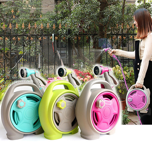 Set of colorful hose reels with a woman using one in an outdoor setting.
