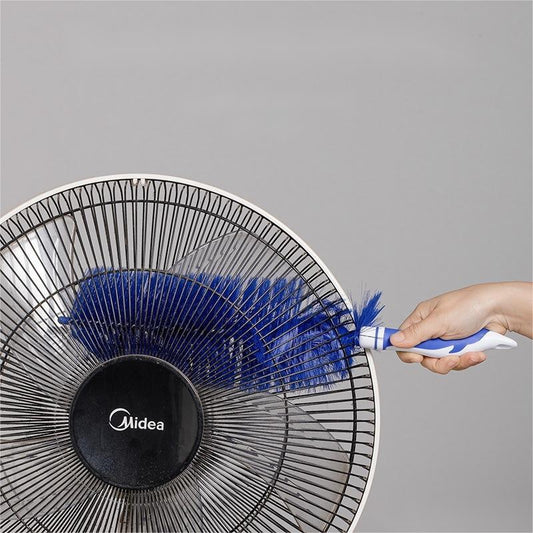 Midea fan being cleaned with a feather duster against a gray background