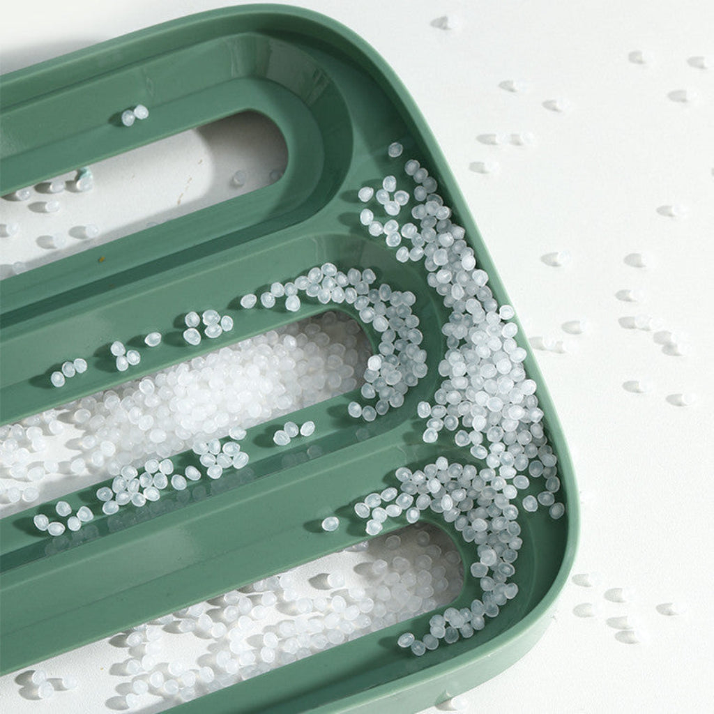 Green plastic tray with clear beads on a white background