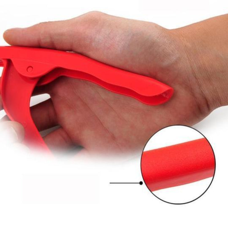 Red plastic tool held in a hand with close-up detail on a white background
