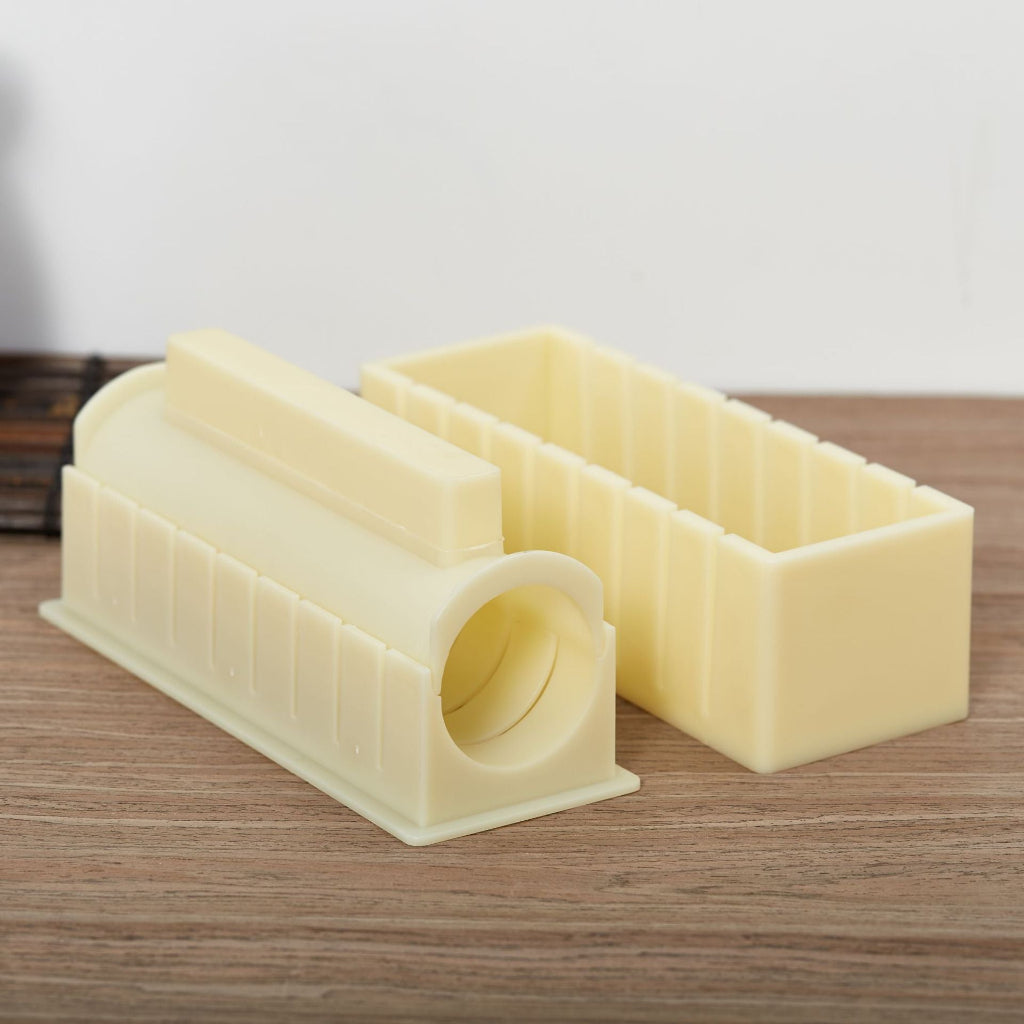 Two beige plastic models on a wooden surface with a neutral background