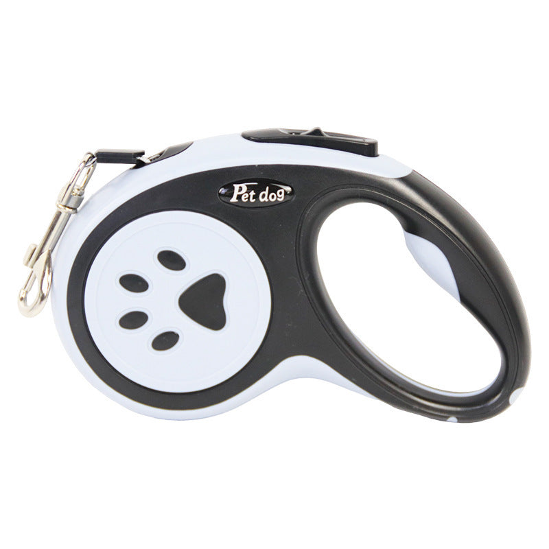 Black and white retractable dog leash with paw design on a white background