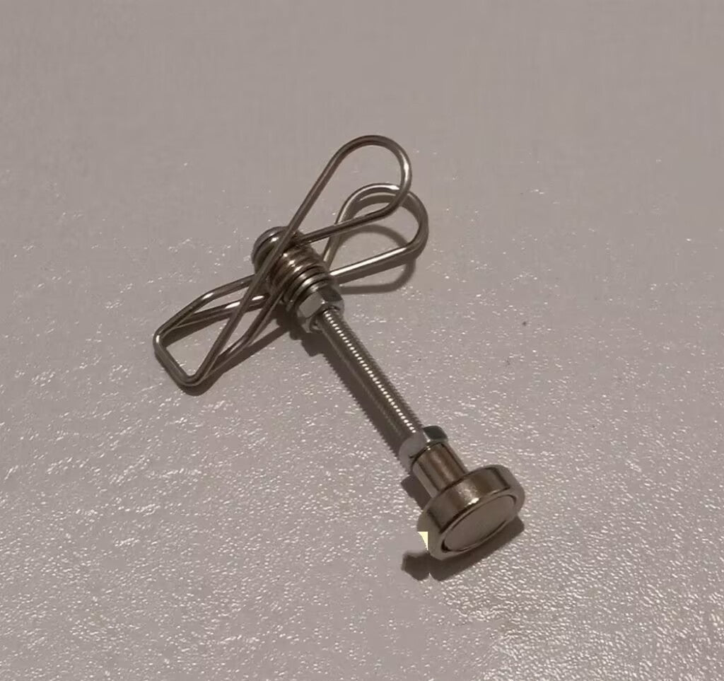 Metal component with a spring on a gray background