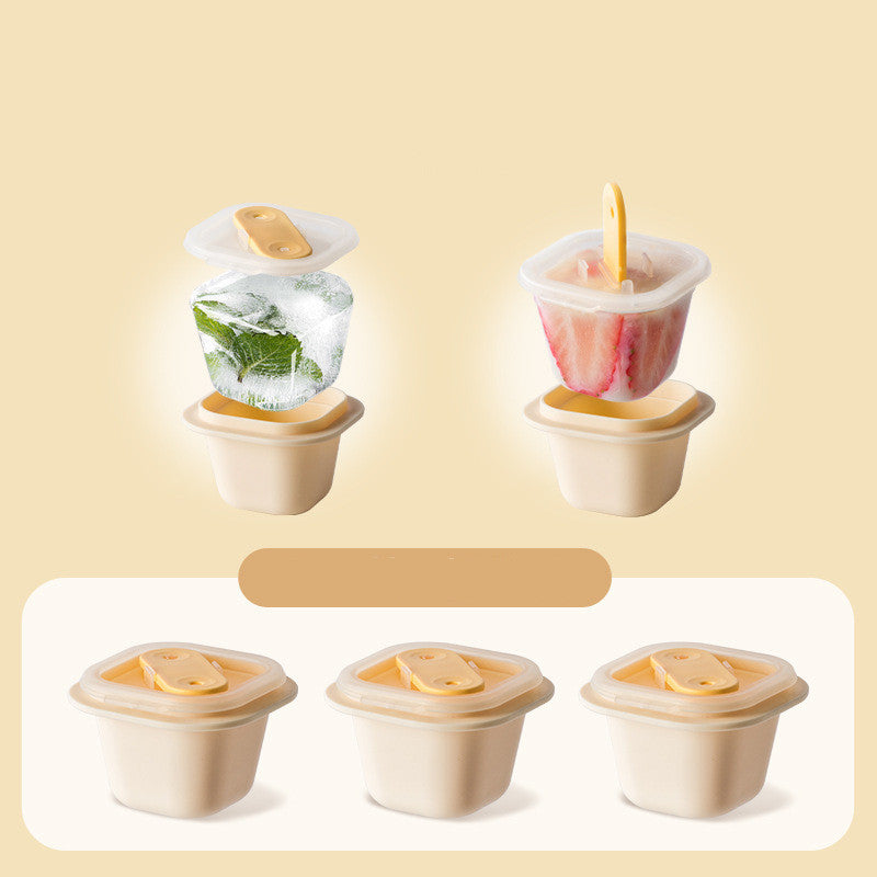 Set of four silicone ice pop molds with lids on a beige background