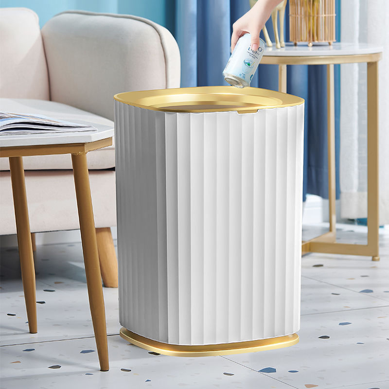 White trash can with gold rim in a living room setting