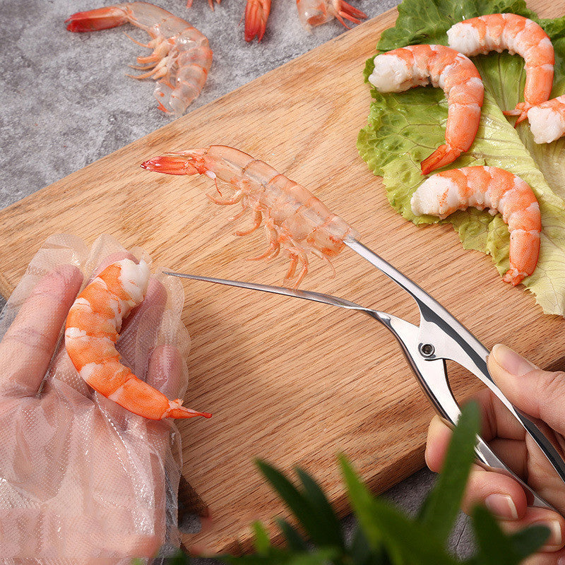 Person preparing shrimp with scissors on a wooden cutting board.