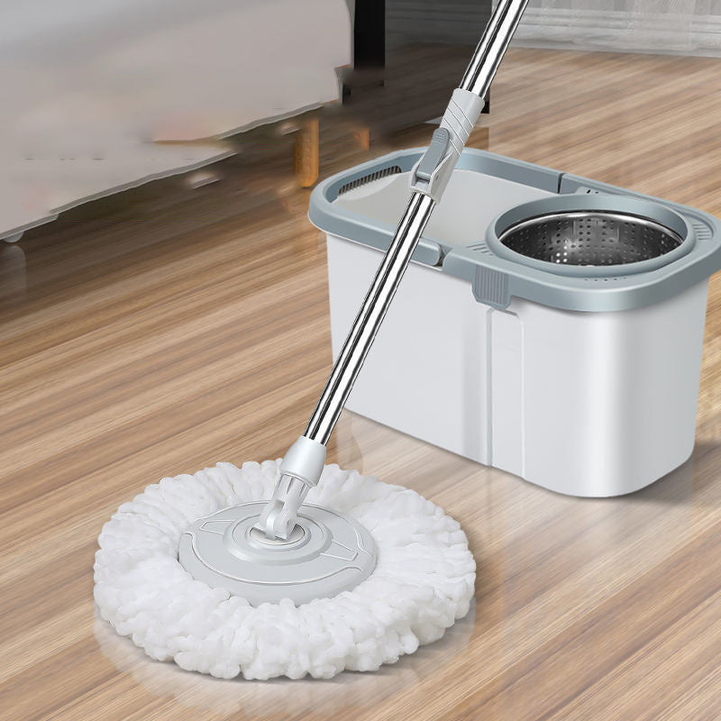 Mop with a white head and gray handle on a wooden floor.