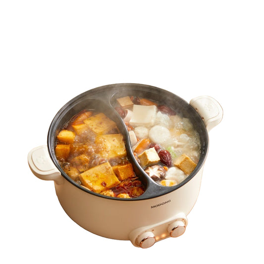 Mandarin Duck Double Pinyin hot pot with food inside on a wooden table.