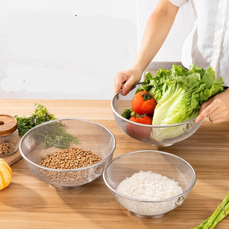 Person holding a colander with vegetables over a bowl of rice on a wooden table.