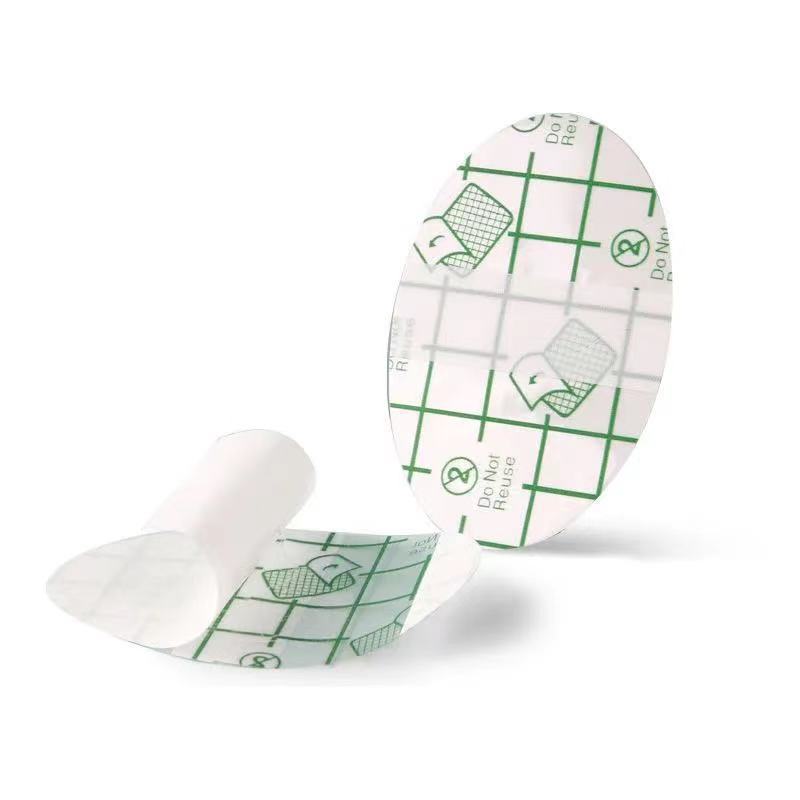 Two medical adhesive patches with green grid patterns on a white background