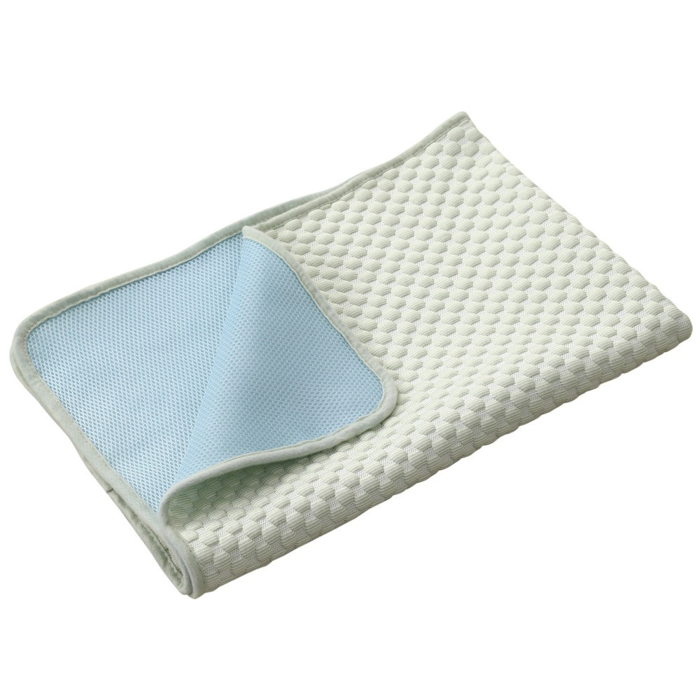 Folded quilt with textured surface and light blue inner lining on a white background
