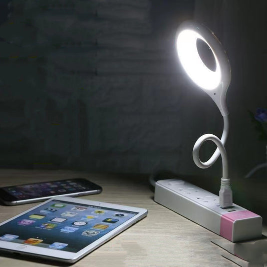 Flexi light on a desk with a tablet and smartphone in the foreground