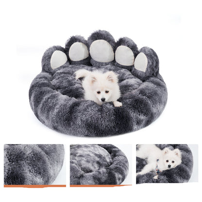 Gray paw-shaped pet bed with a white dog inside, featuring text about the product's benefits.