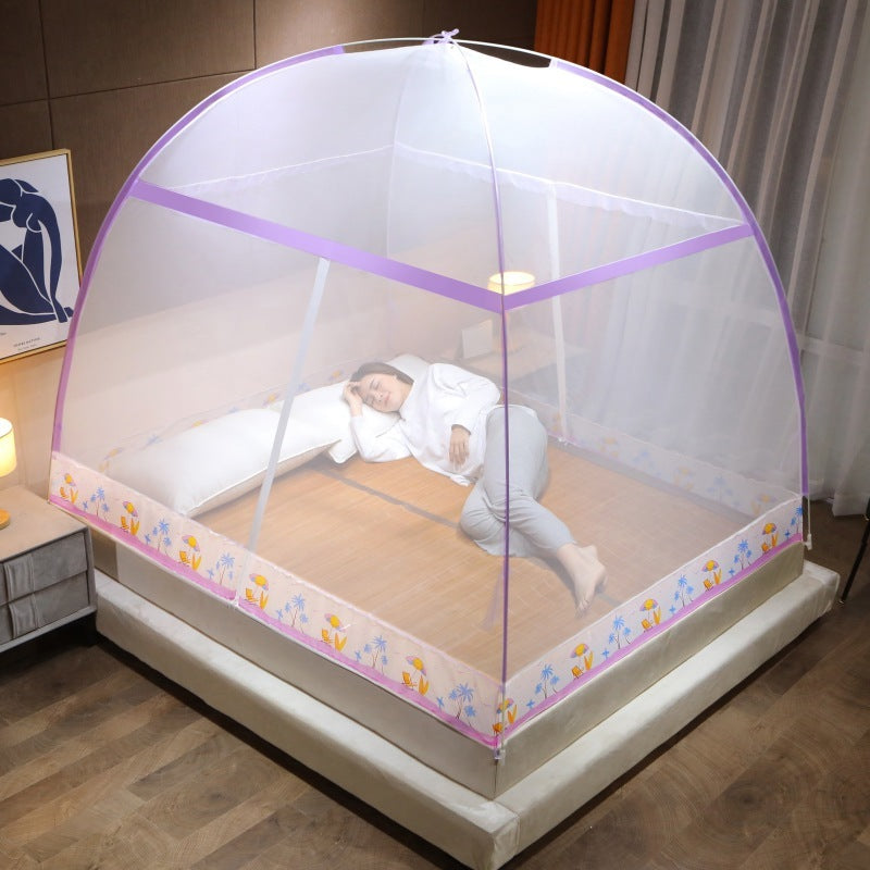 Person lying in bed under a children's mosquito net in a bedroom.