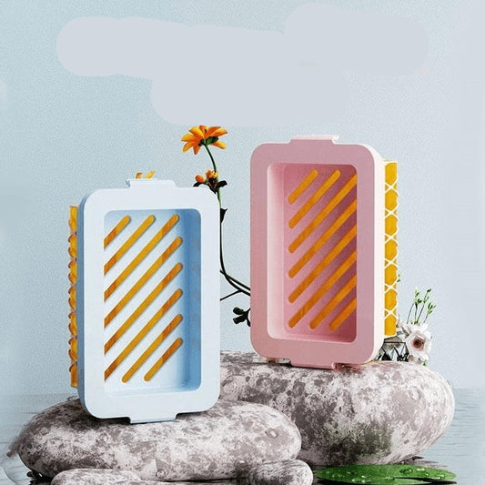 Two high-elastic mesh soap foaming boxes on stones with a light blue background