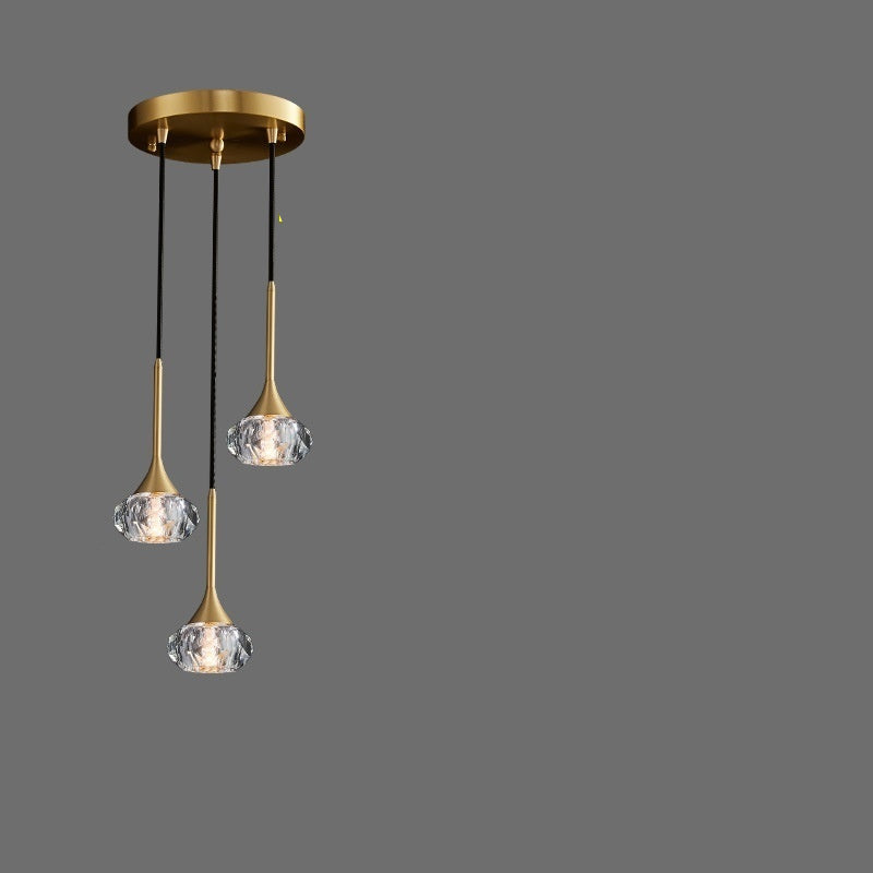 Three-head disc pendant light with crystal elements on a gray background