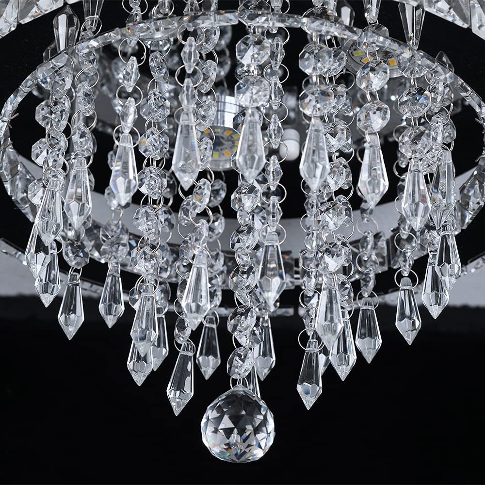 Close-up of a crystal chandelier with clear glass droplets against a black background