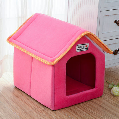 Pink pet house with a brand label on a wooden floor