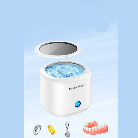 Ultrasonic cleaner with transparent top cover on a light blue background